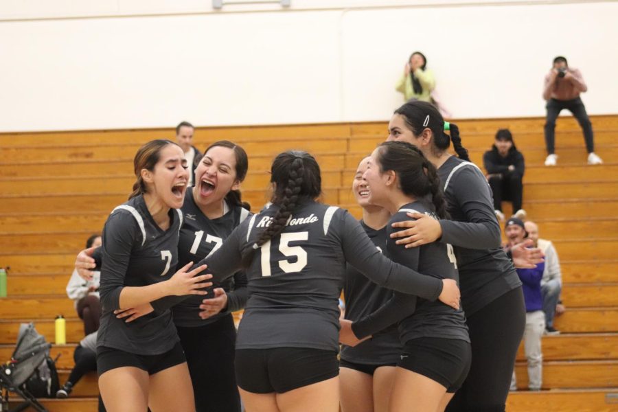 The Lady Roadrunners are overjoyed after scoring their winning point. 