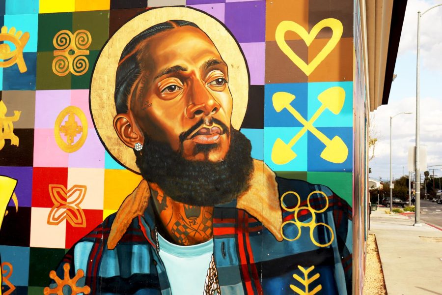 The mural painting of Nipsey Hussle is on a bank in the intersection of Crenshaw and Slauson where The Marathon Clothing store is located.
