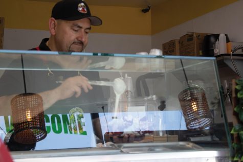 Sandro Magaña serves a multitude of hot and cold treats at his and his familys new shop in Huntington Beach. Calif.